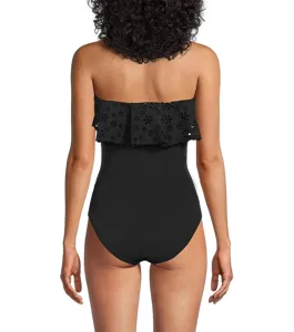 Back detail of a black strapless one-piece swimsuit featuring elegant laser-cut floral ruffles.