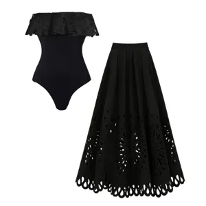 Black strapless cutout one-piece swimsuit and matching maxi skirt set for women.