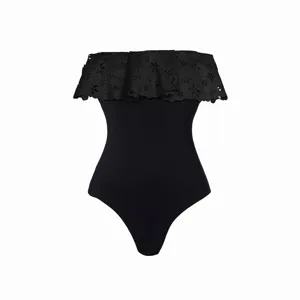 Detailed view of the black strapless one-piece swimsuit featuring an eyelet ruffle overlay.