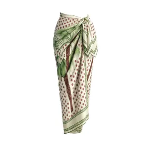 Tropical palm tree print beach sarong detail, lightweight wrap skirt for summer resort vacation.
