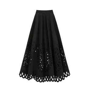 Detailed view of the elegant black high-waisted pleated long skirt with intricate cut-out hem.