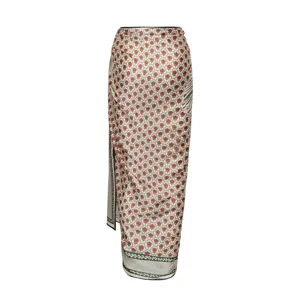 Elegant women's long wrap skirt featuring vintage floral print and chic geometric hem design.