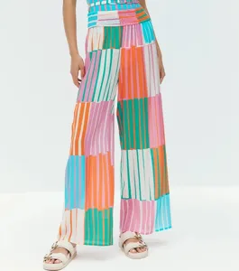 Colorful striped wide leg beach pants detail view, high waist casual trousers for summer vacation.