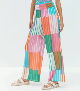 Detailed view of colorful striped beach jumpsuit and vacation swimwear set, stylish resort wear.
