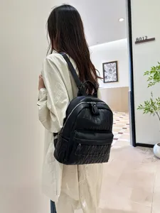Black quilted leather backpack for women, casual soft PU school bag with spacious capacity.