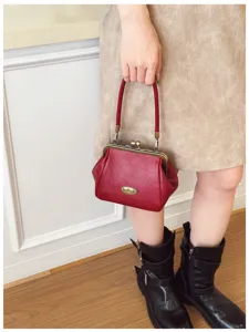 Vintage red kiss-lock handbag for women, elegant retro mini top handle purse, chic daily bag.