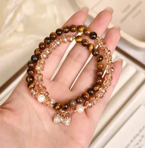 Bracciale doppio cerchio artigianale rétro in occhio di tigre e cristallo con fiocco.