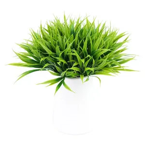 Artificial potted plastic green grass in white vase for home living room decor and office display.