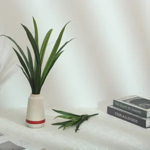 Artificial soft rubber orchid leaves detail shot, realistic greenery for home floral decor.