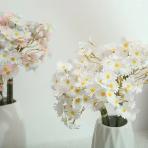 Detailed shot of artificial daisy flower bouquet in white ceramic vase, perfect for home decor.