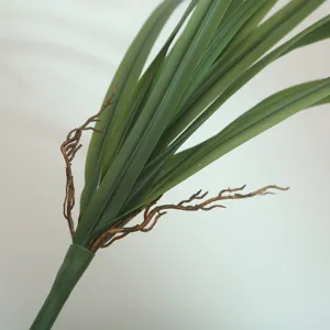 Close-up of artificial soft rubber orchid leaves with brown roots for floral decor.
