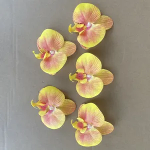 Artificial phalaenopsis orchid flower heads for decor and DIY wedding arrangements.