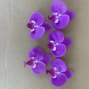 Close up detail view of purple artificial phalaenopsis orchid flower heads for DIY floral decor.