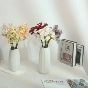 Artificial daisy flower bouquet with white ceramic vase for home living room desk decor detail