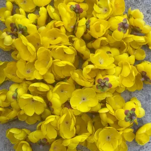 Yellow artificial flower heads close up view for DIY crafts and floral decoration