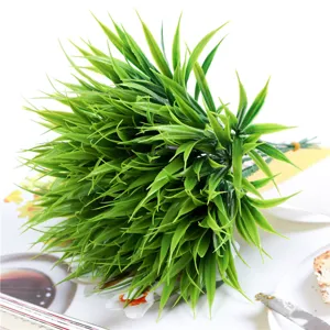 Artificial plastic grass detail view, 7-fork green plant branch for home decor closeup.