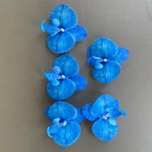Blue artificial orchid flower heads for wedding decoration, DIY craft and floral details.