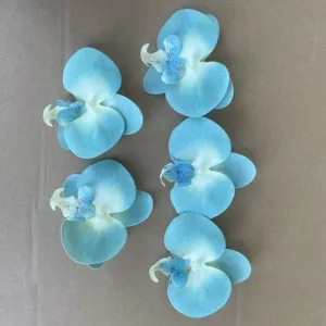 Detailed top shot of large artificial blue Phalaenopsis orchid flower heads for DIY crafts.