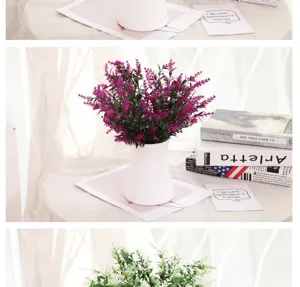 Artificial lavender flower bouquet in white vase for home decor, plastic green plant detail.