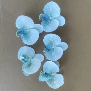 Detailed close-up of artificial phalaenopsis orchid flower heads, blue gradient wedding DIY decor.