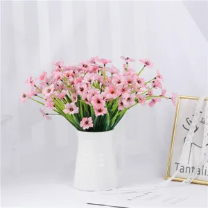 Pink artificial silk violet flower bouquet detail in white ceramic vase for home decor.