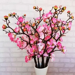 Artificial plum blossom branch detail, pink faux floral decor for home and wedding room.
