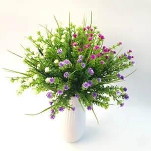 Detailed view of artificial floral arrangement bouquet with purple and white small blossoms.