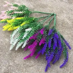 Artificial lavender flower bunch detail, colorful plastic fake floral decor for home.