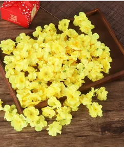 Yellow artificial plum blossom flower petals detail, ideal for wedding decor and crafts.