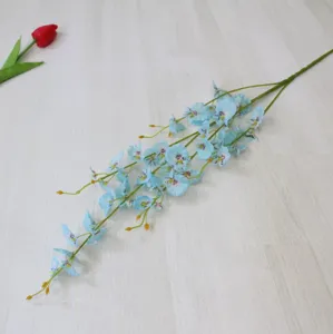 Close-up detail of artificial blue dancing orchid silk flower branch, perfect for home decor display.
