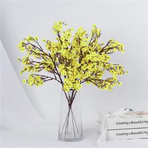 Artificial yellow flowers bouquet in glass vase detail, elegant home decor wedding floral setup.