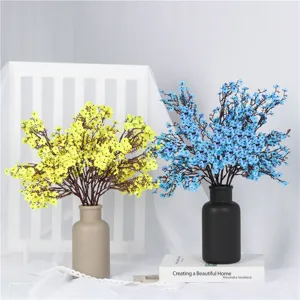 Colorful artificial baby breath flowers in ceramic vases, perfect home decor and wedding arrangement.
