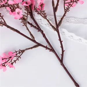 Artificial pink flower branch bouquet detail shot for home wedding party decoration and crafts.