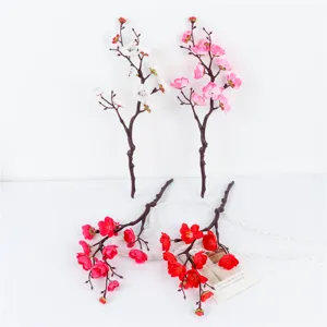 Detailed close-up of artificial plum blossom branches, showing realistic floral textures and stems.