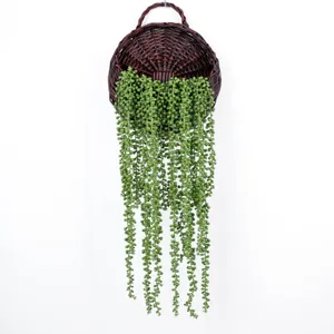 Artificial string of pearls hanging plant in wicker basket for creative wall decor detail