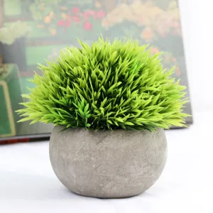 Artificial green grass plant detail, miniature faux potted plant for indoor home tabletop decor.