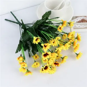 Artificial sunflower bouquet detail shot, vibrant yellow silk flowers with green stems for home decor.