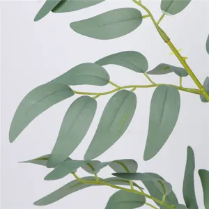 Artificial willow leaf branch detail shot, fake green plant for rustic wedding floral decor.