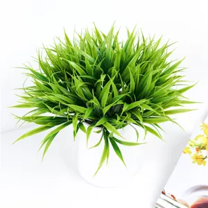 Artificial plastic spring grass potted plant detail, green faux plant decoration for home office