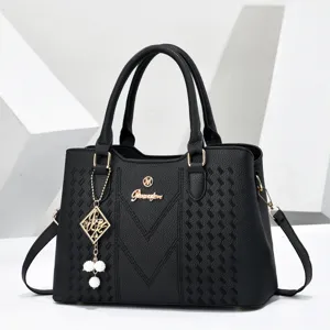 Black leather top handle handbag with geometric embossed pattern, elegant tote bag for daily commute.