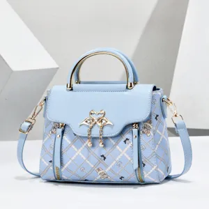 Light blue stylish top handle crossbody bag for women, versatile summer handbag with chic metal swans.