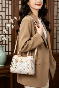 Stylish women's crossbody shoulder bag with chic plaid pattern and elegant golden hardware details.