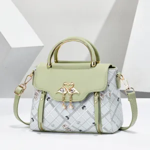 Chic fashion women's handbag with plaid pattern, metal handle, and elegant design.