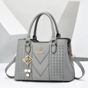 Grey chevron textured women handbag with top handles, chic pearl charm and shoulder strap.