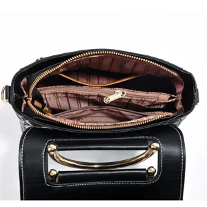 Black fashion top handle shoulder bag interior detail, featuring multiple compartments and zip.