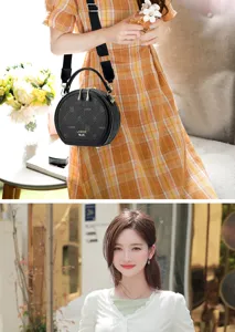 Stylish black round crossbody bag for women, PU leather trendy shoulder bag with wide strap.