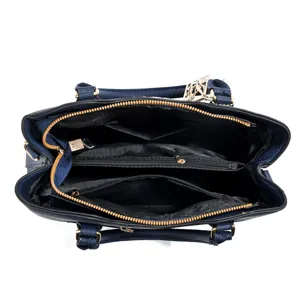 Blue women tote handbag top view showing spacious interior compartments and golden zippers.