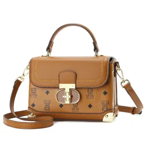 Stylish brown top-handle crossbody bag with elegant lock closure and vintage print.