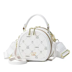 White round PU leather crossbody bag for women, stylish top-handle shoulder handbag.