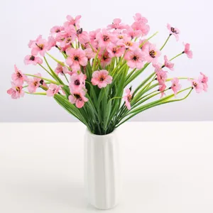 Artificial pink silk flower bouquet in a white ceramic vase for home decor and floral arrangements.